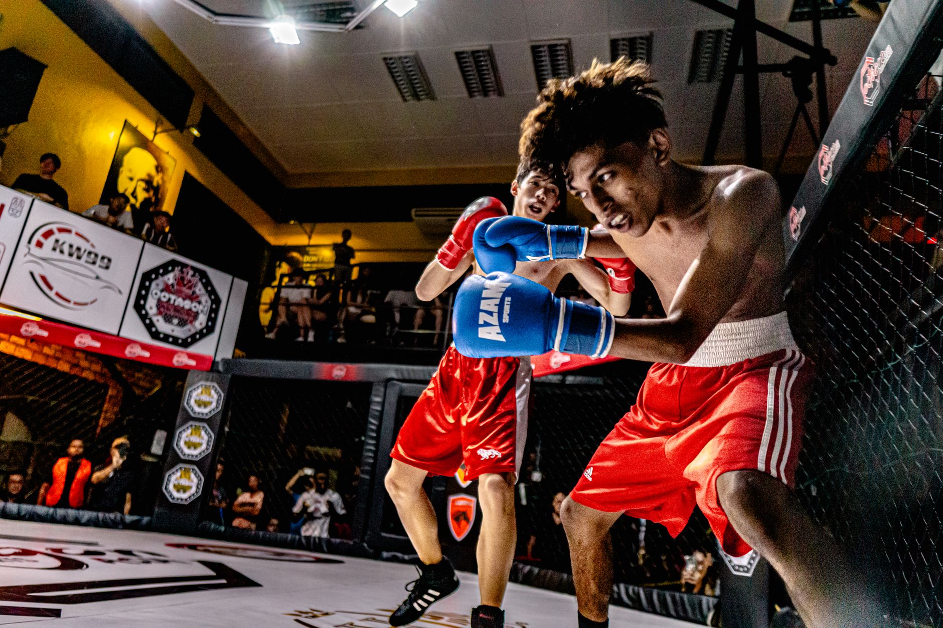 A dramatic MMA fight captured in George Town, Malaysia, showcasing action and athleticism.