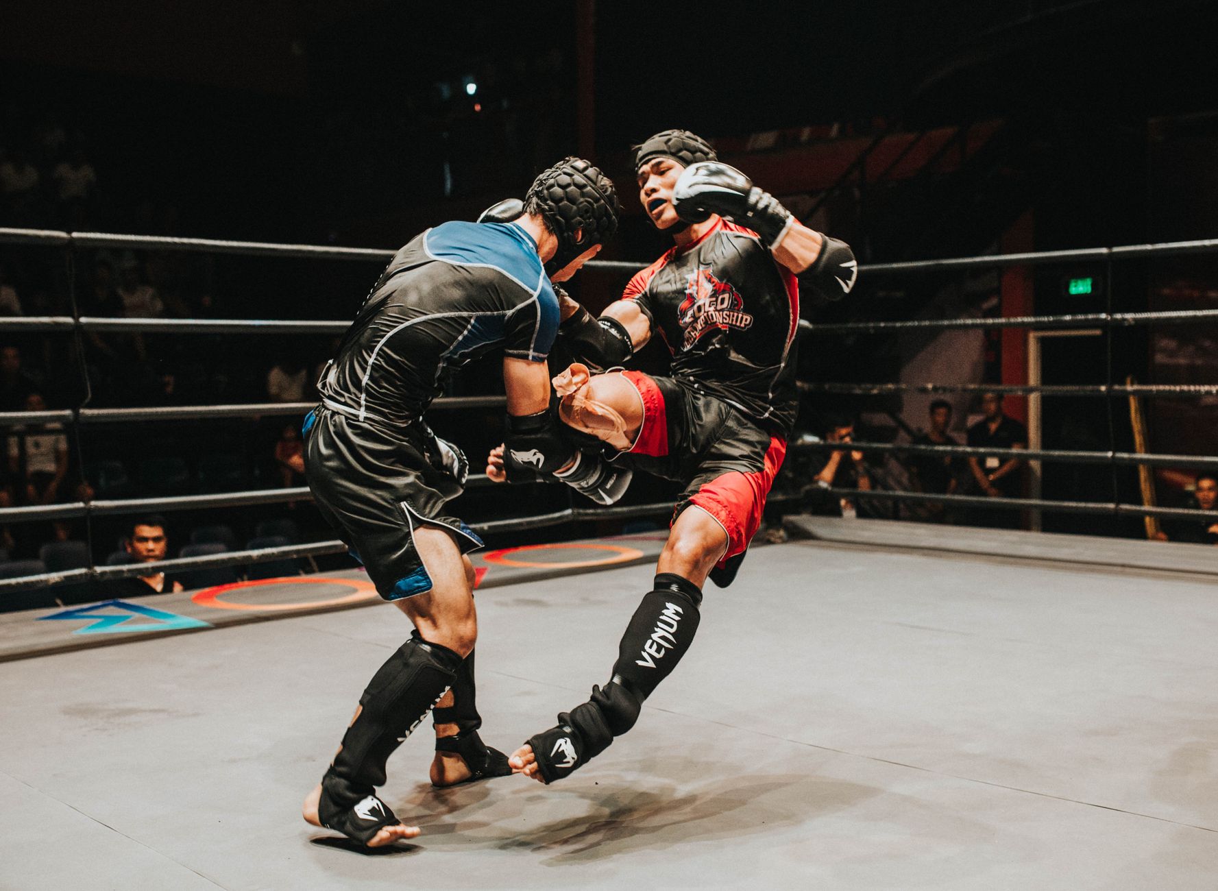 Exciting mixed martial arts fight captures powerful kick in action inside the ring.