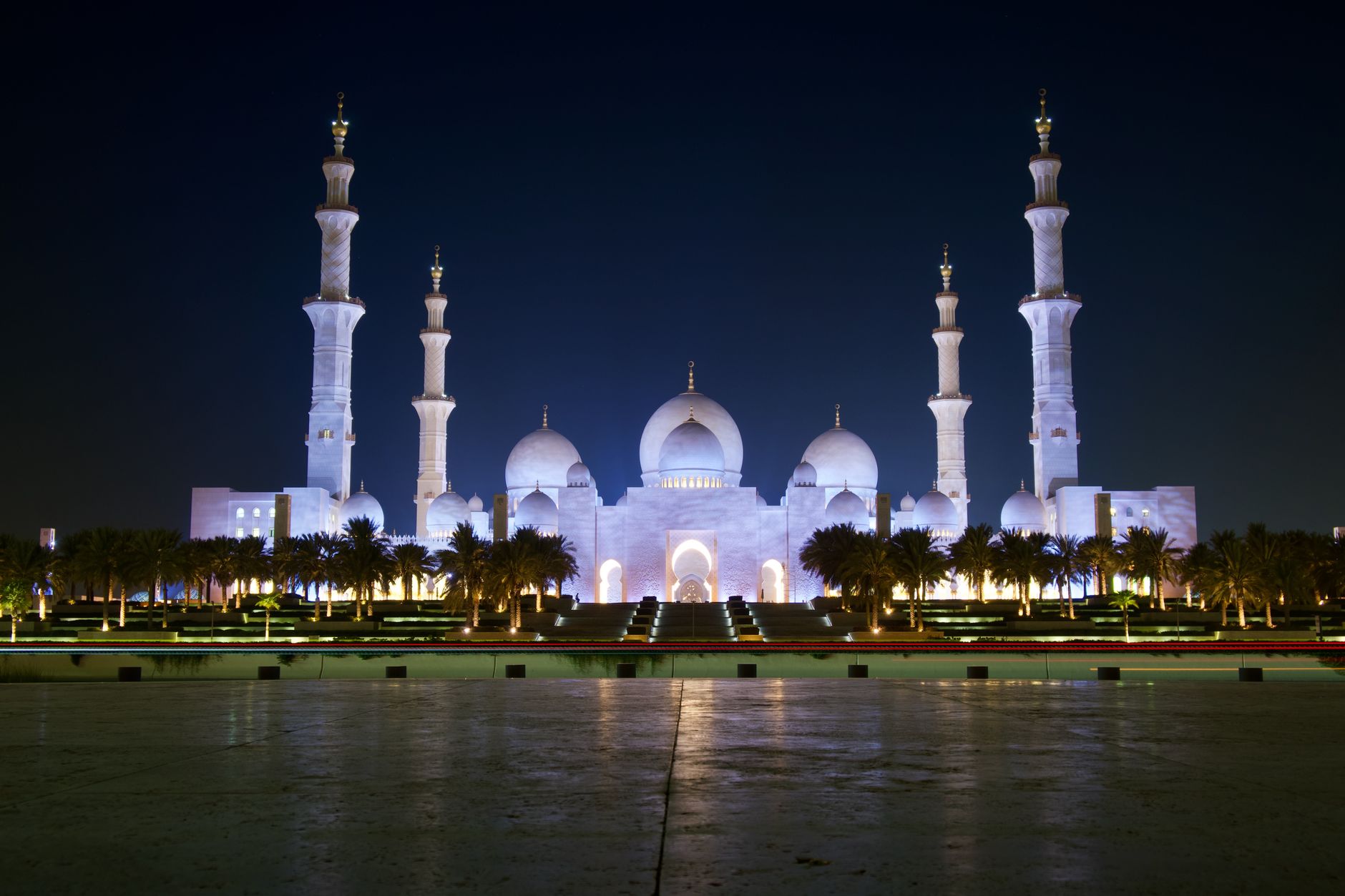Stunning night view of the Sheikh Zayed Grand Mosque in Abu Dhabi, UAE, beautifully lit.