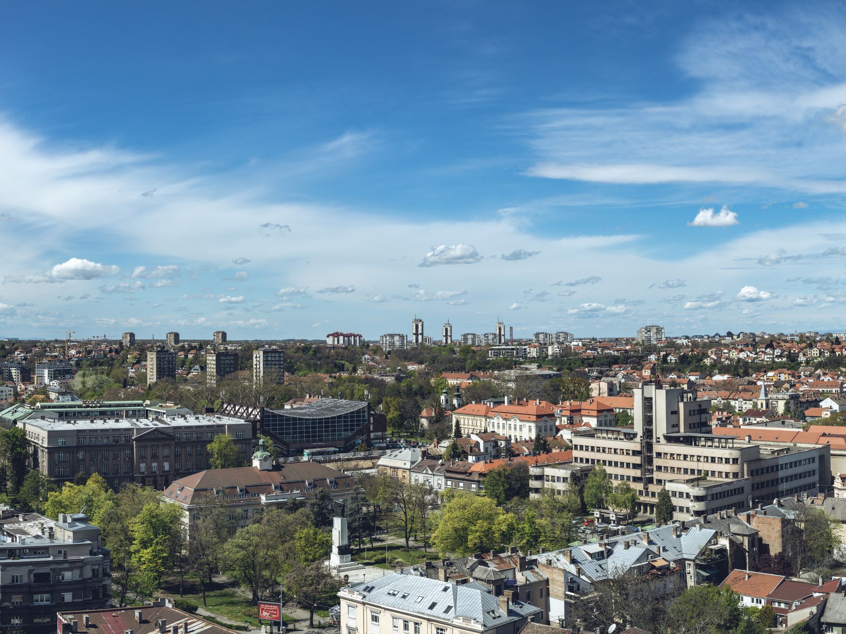 Stunning aerial view of Belgrade showcasing its skyline and vibrant city life under a bright blue sky.