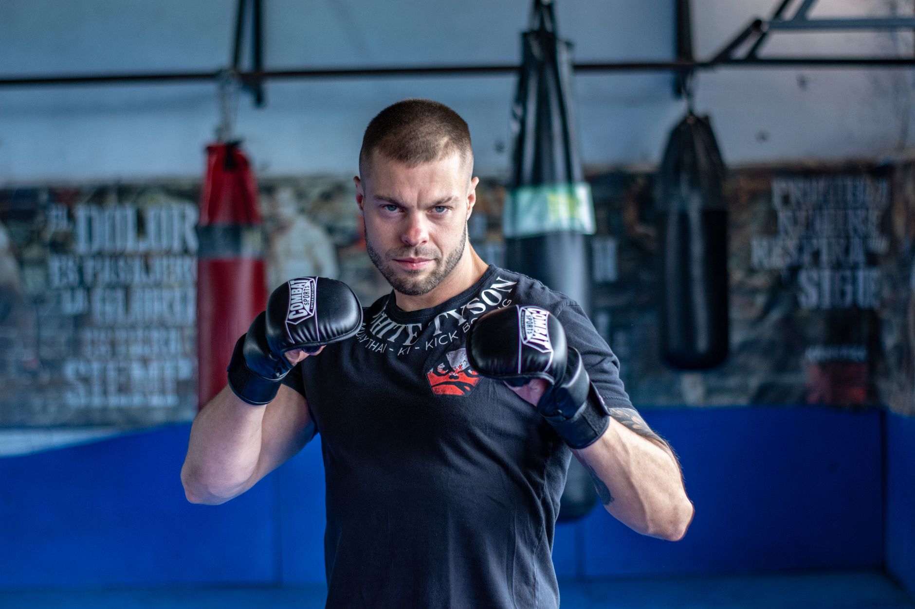 A determined martial artist practicing in a gym, showcasing strength and focus.
