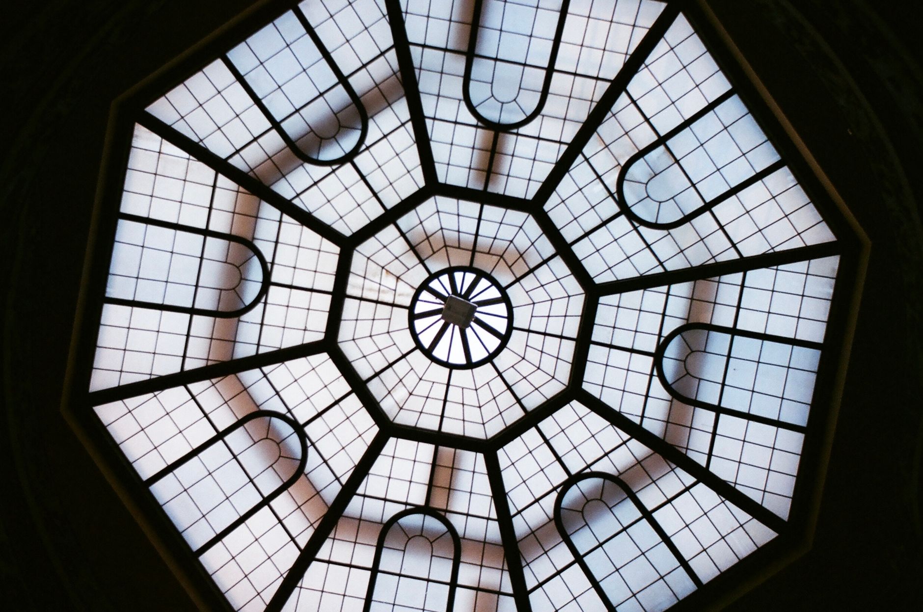 A stunning view of an octagonal skylight featuring an elegant geometric glass pattern and symmetrical design.